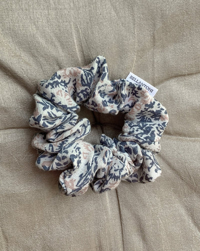 Dark teal, pale pink and white speckled reclaimed woven fabric scrunchie ethically sewn in Canada.