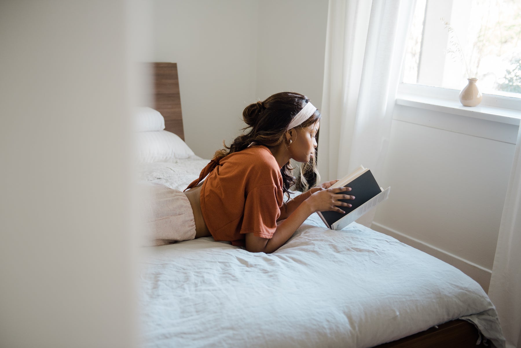 Bellantoni Loyalty Program - woman reading a book on a bed