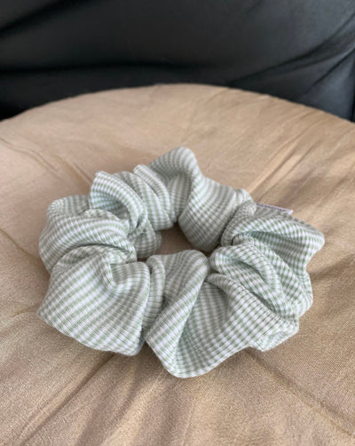 Reclaimed cotton sage green and white striped scrunchie, ethically handmade in Canada.