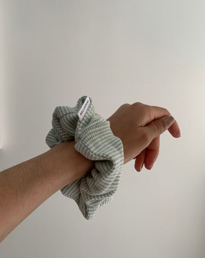 Reclaimed cotton sage green and white striped scrunchie, ethically handmade in Canada.