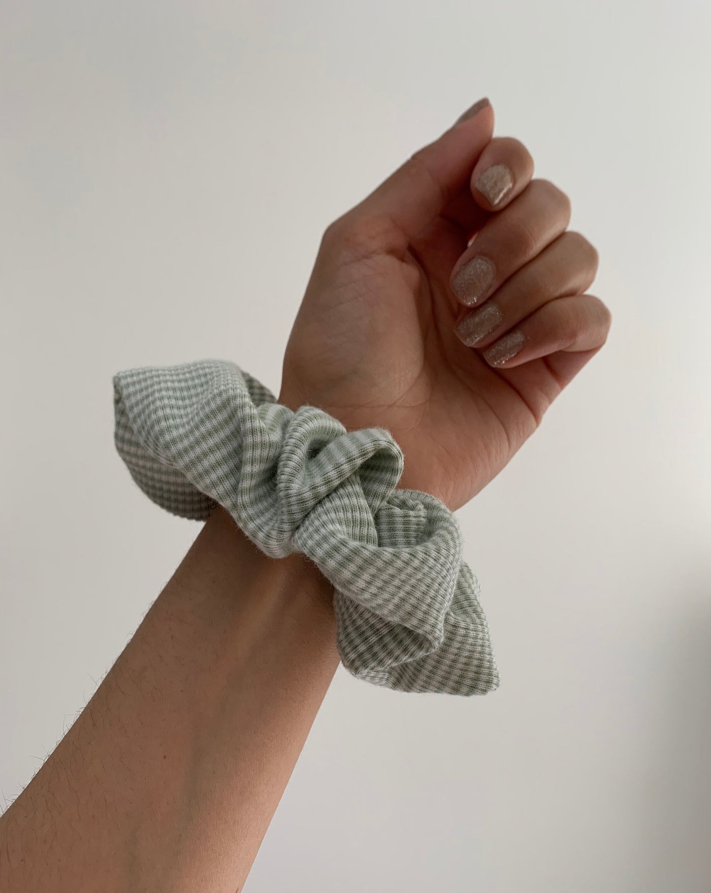 Reclaimed cotton sage green and white striped scrunchie, ethically handmade in Canada.