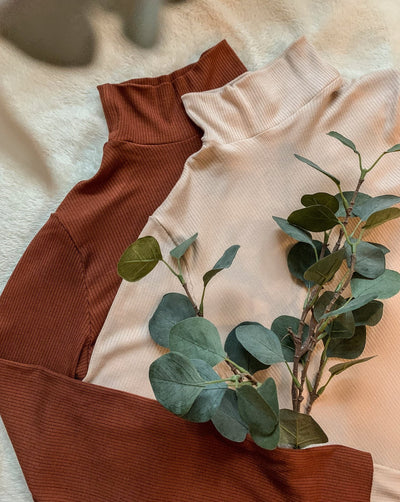 Ribbed Tencel longsleeve turtlenecks in beige and pecan brown.