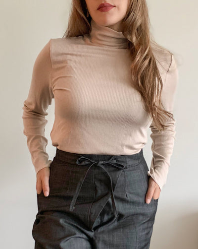 Ribbed beige Tencel longsleeve turtleneck worn with black denim.