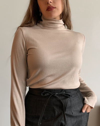 Ribbed beige Tencel longsleeve turtleneck worn with black denim.