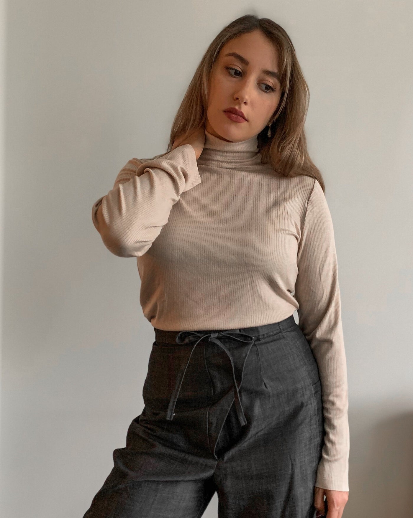 Ribbed beige Tencel longsleeve turtleneck worn with black denim.