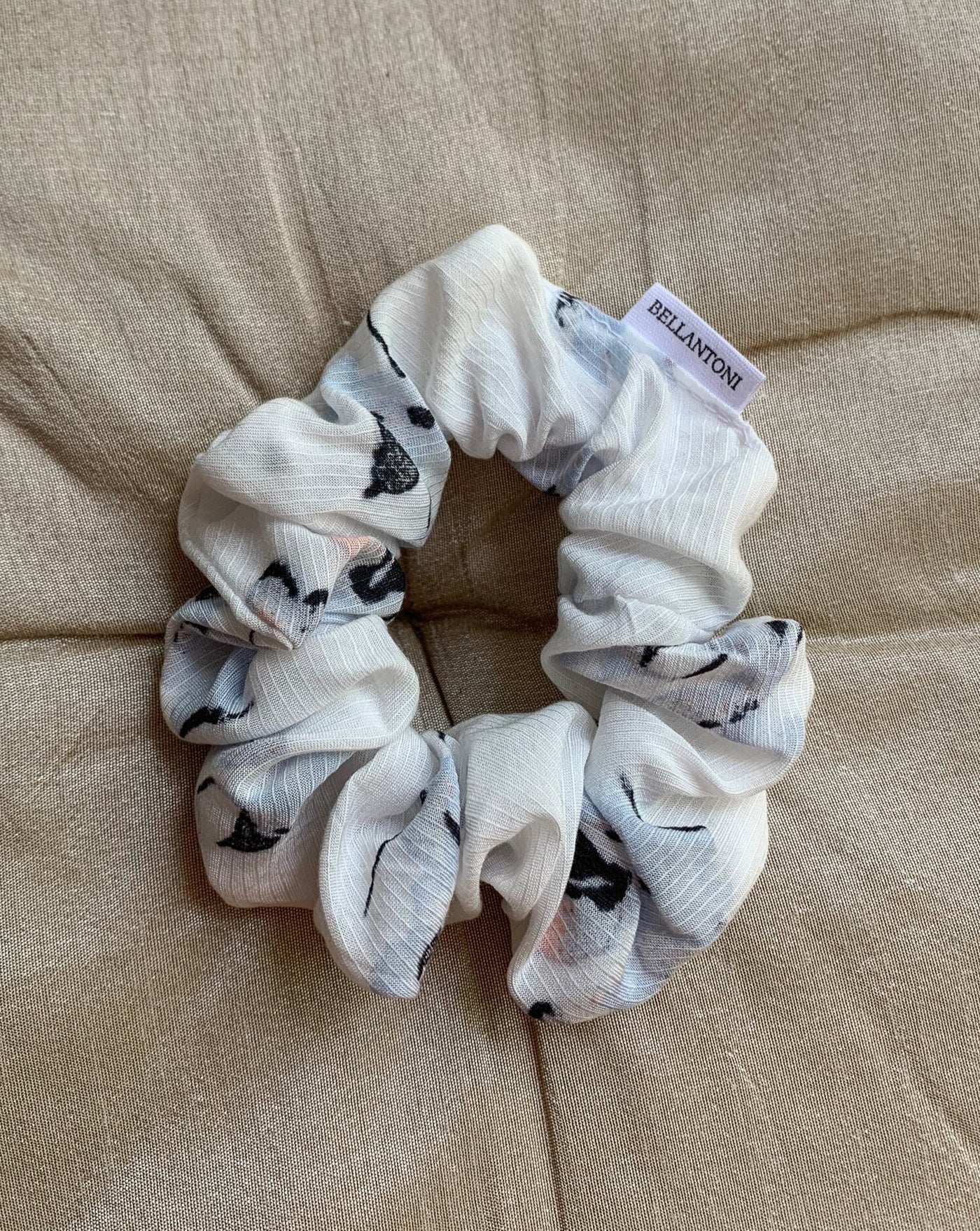 Light blue, pale pink, black and white floral reclaimed woven fabric scrunchie ethically sewn in Canada.