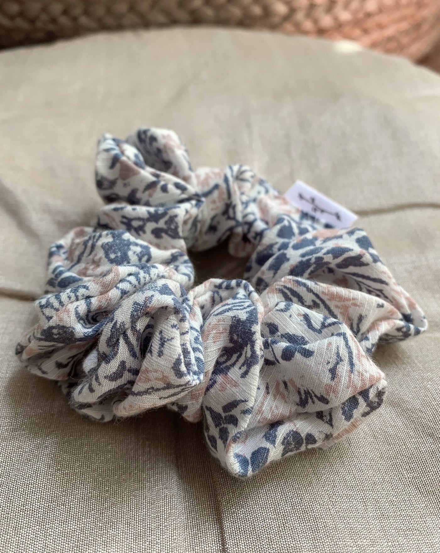 Dark teal, pale pink and white speckled reclaimed woven fabric scrunchie ethically sewn in Canada.
