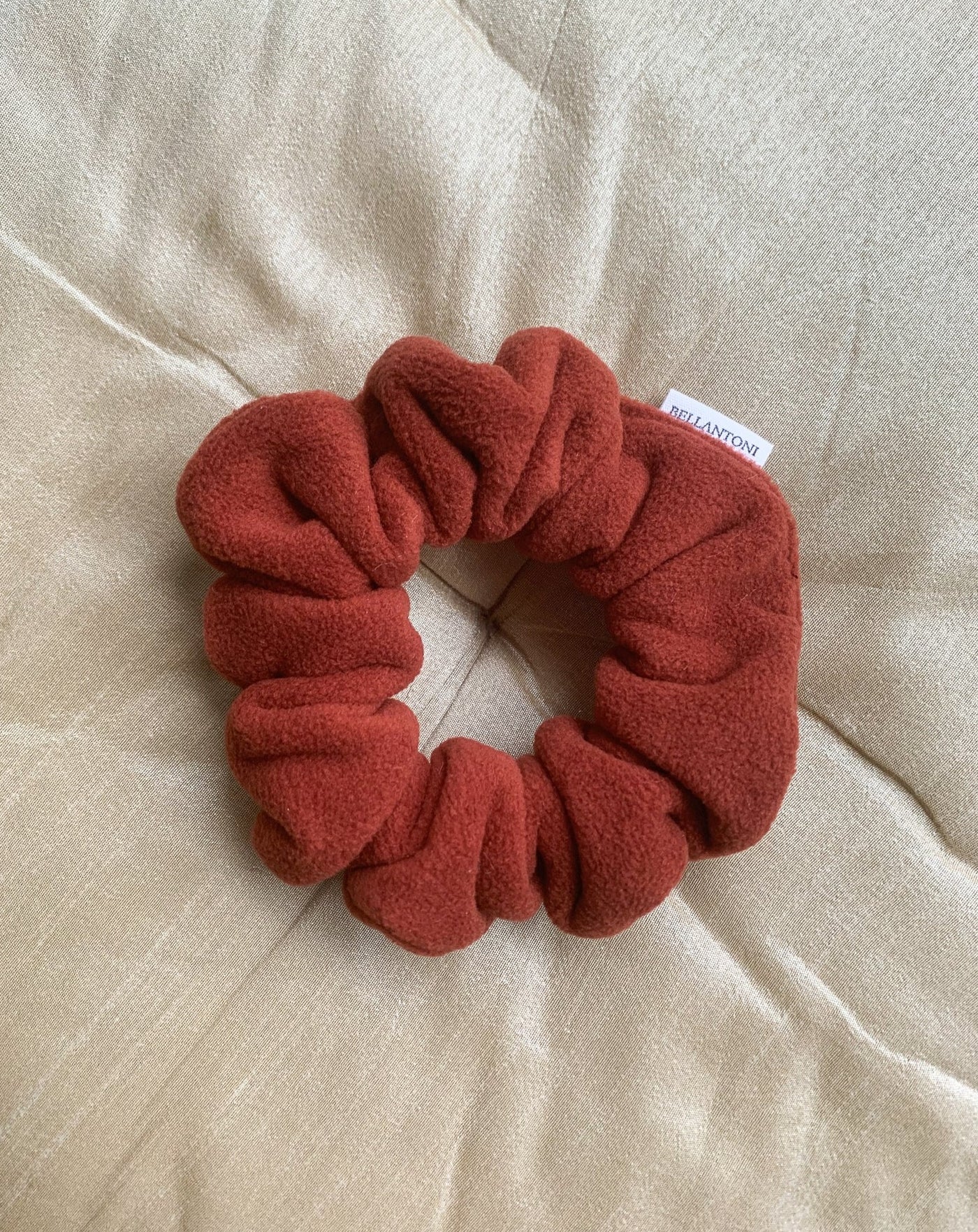 Recycled fleece pumpkin scrunchie flat lay.