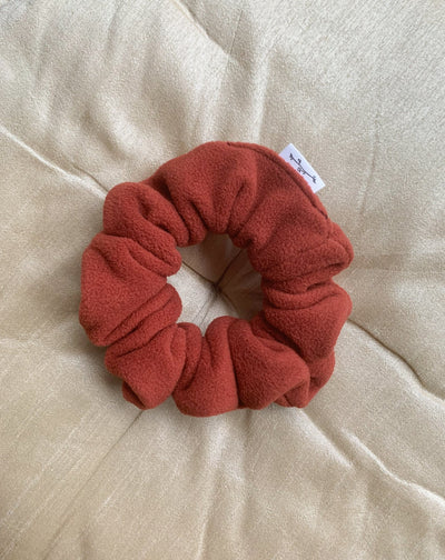 Recycled fleece pumpkin scrunchie flat lay.