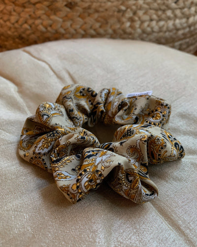 Beige, black, yellow and white paisley reclaimed silk fabric scrunchie ethically sewn in Canada.
