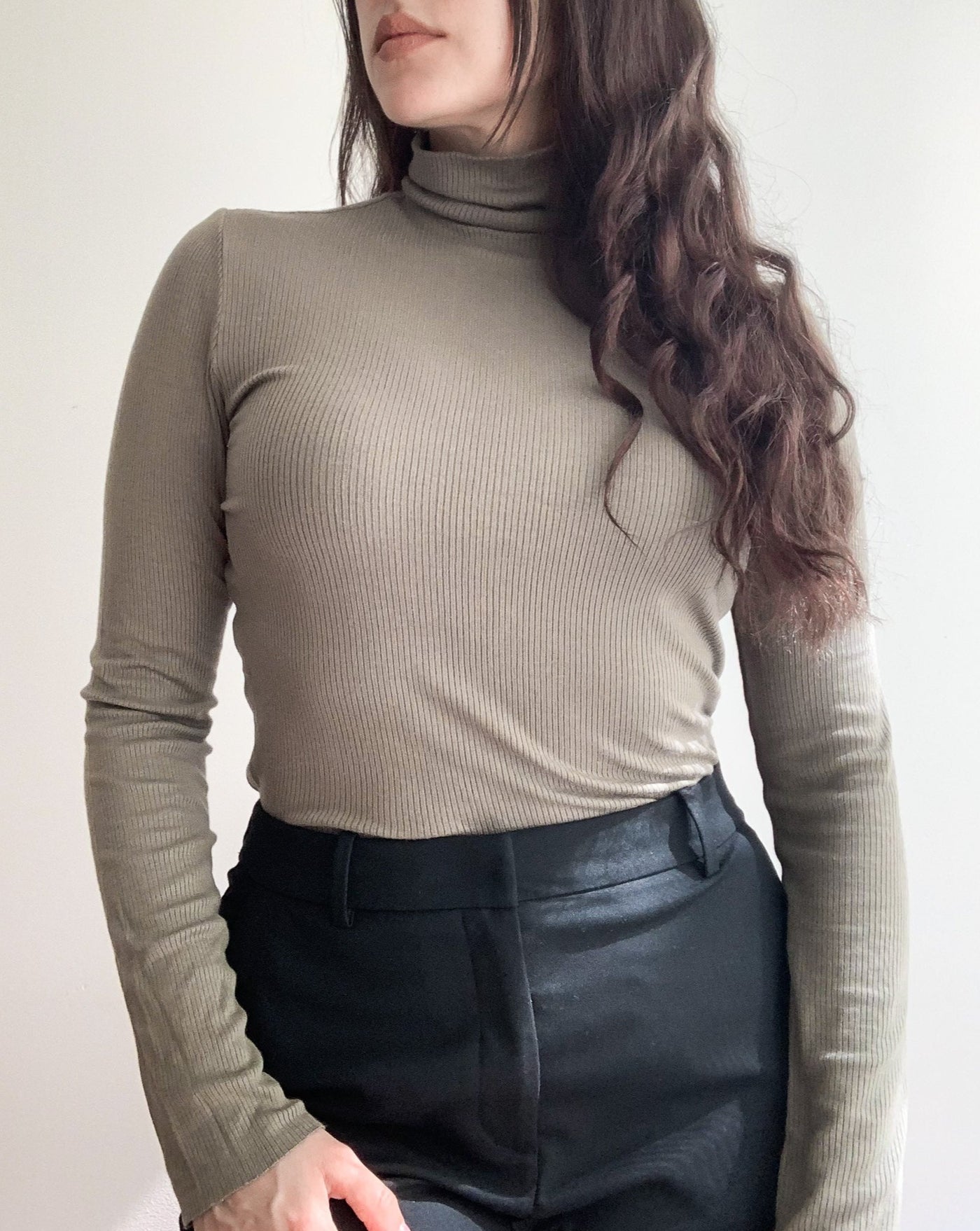 Tencel ribbed turtleneck in the colorur olive, worn by brunette model.