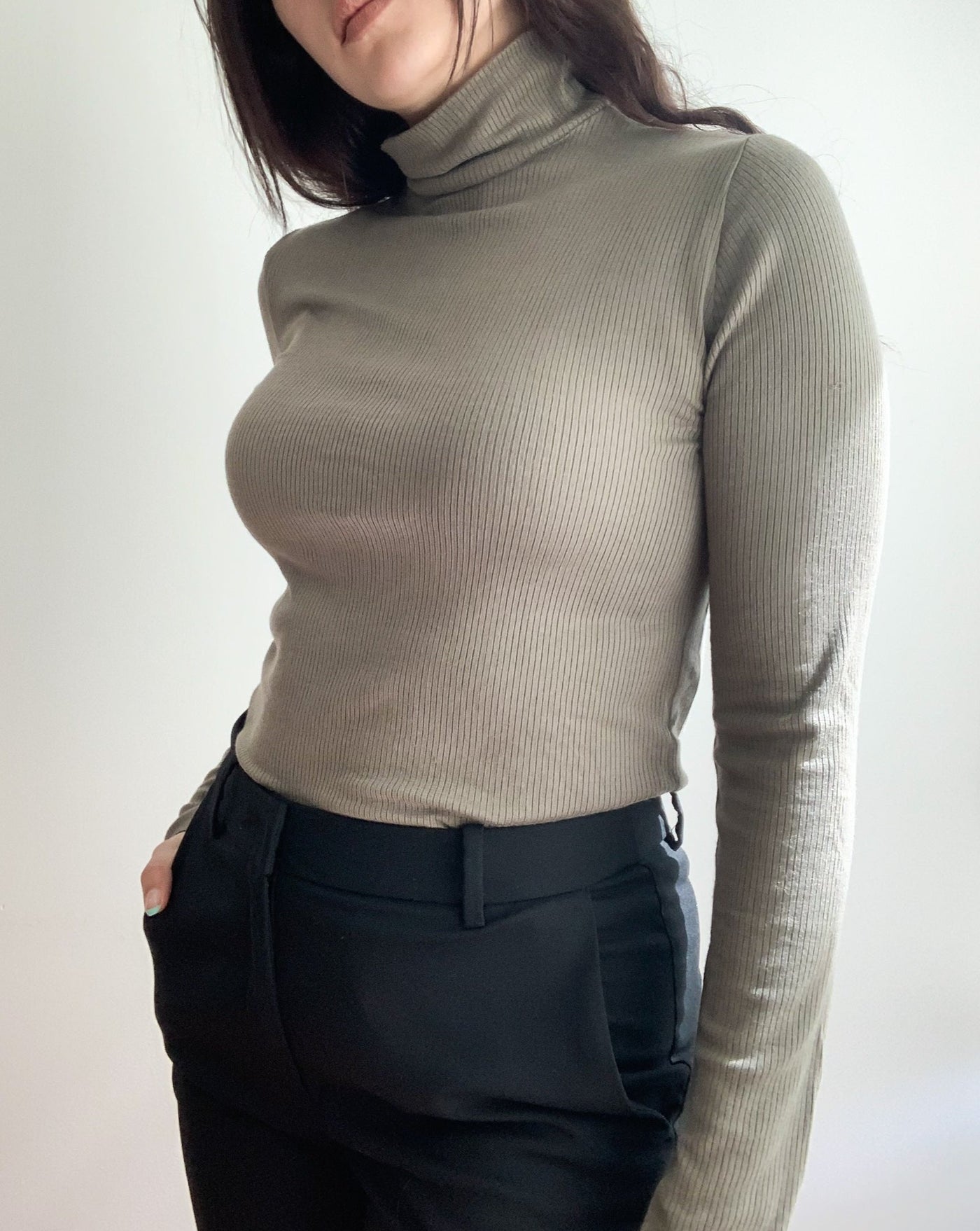 Tencel ribbed turtleneck in the colorur olive, worn by brunette model.