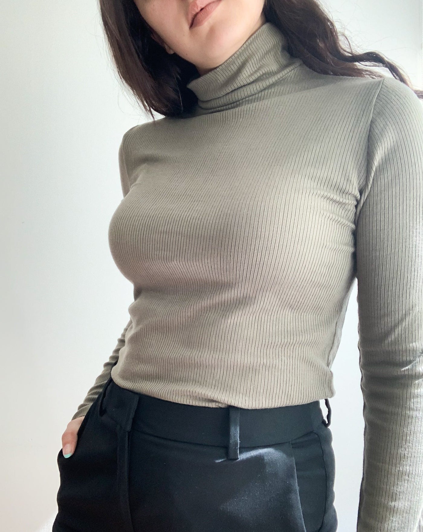 Tencel ribbed turtleneck in the colorur olive, worn by brunette model.