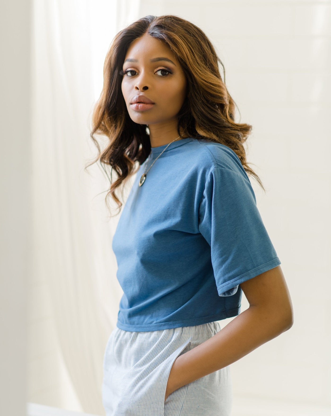 Blue tencel organic cotton reversible tie top worn by standing model.