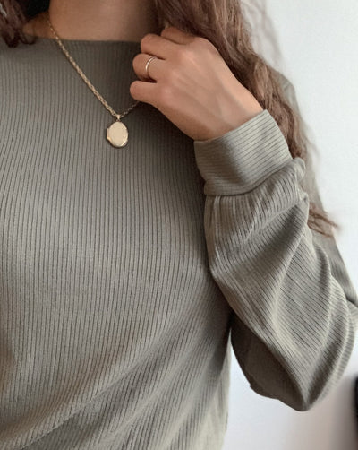 Sustainable olive green ribbed tencel reversible shirt with gold necklace.