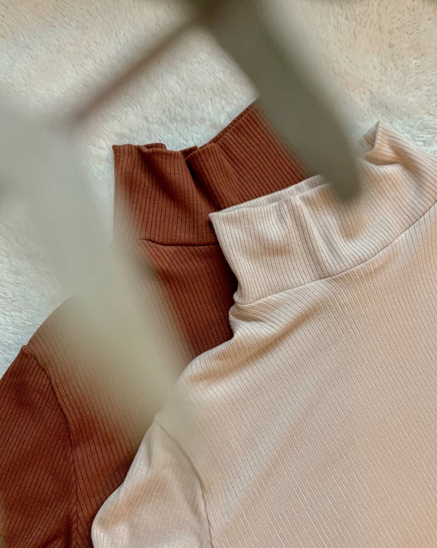 Ribbed Tencel longsleeve turtlenecks in beige and pecan brown.