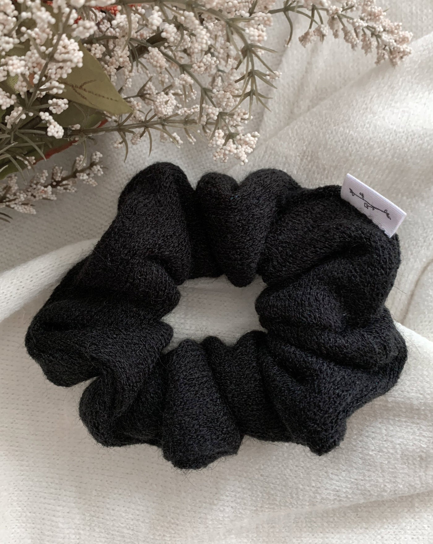 Black reclaimed sweater scrunchie ethically sewn in Canada.