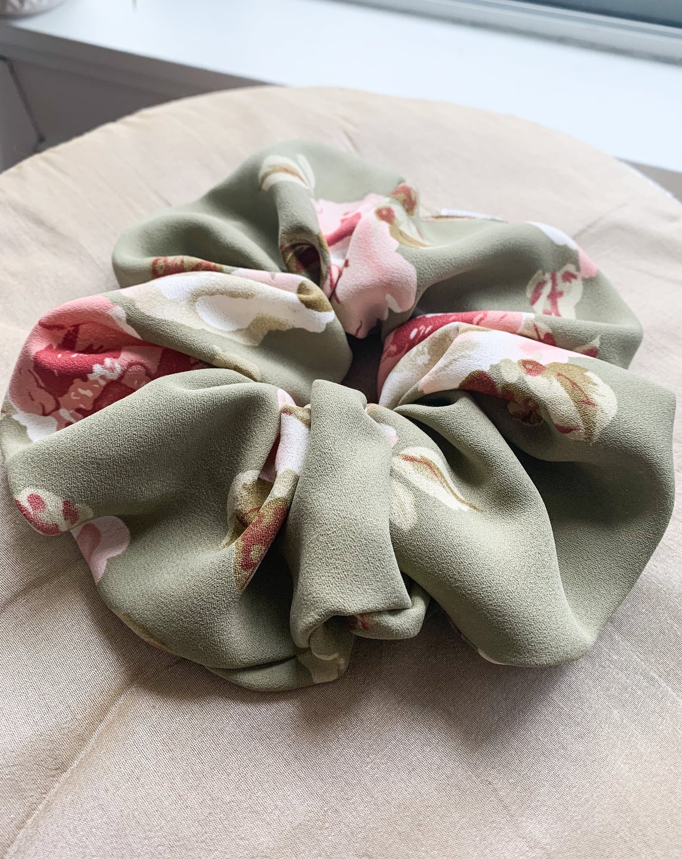 Fluffy Grande Luxe floral green scrunchie closeup.