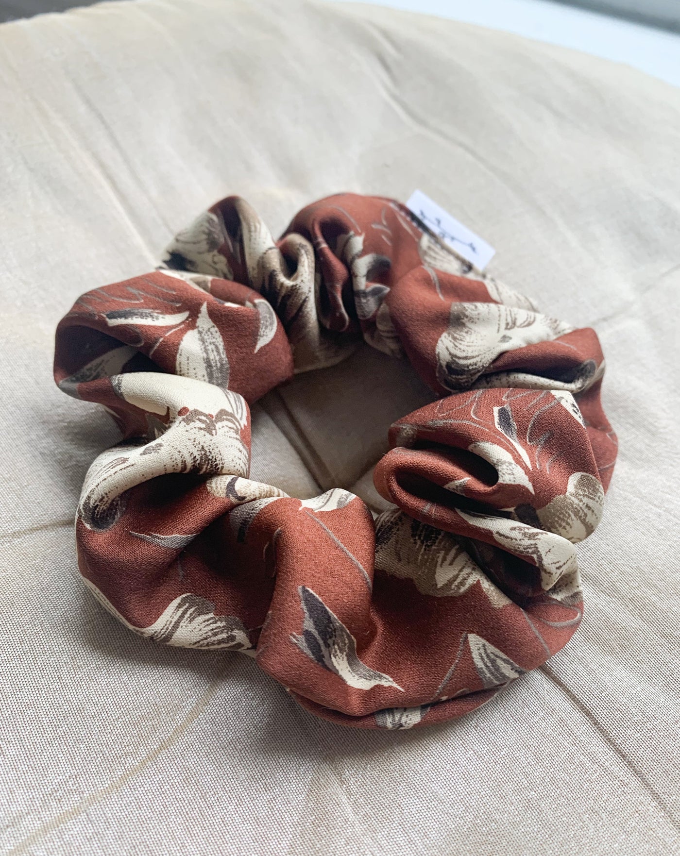Reclaimed Sateen brown floral scrunchie close up.