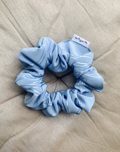 Frozen blue shine floral decal scrunchie flat lay.