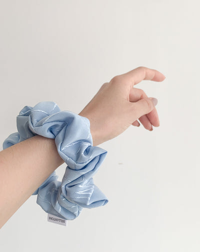 Frozen blue shine floral decal scrunchie on arm.