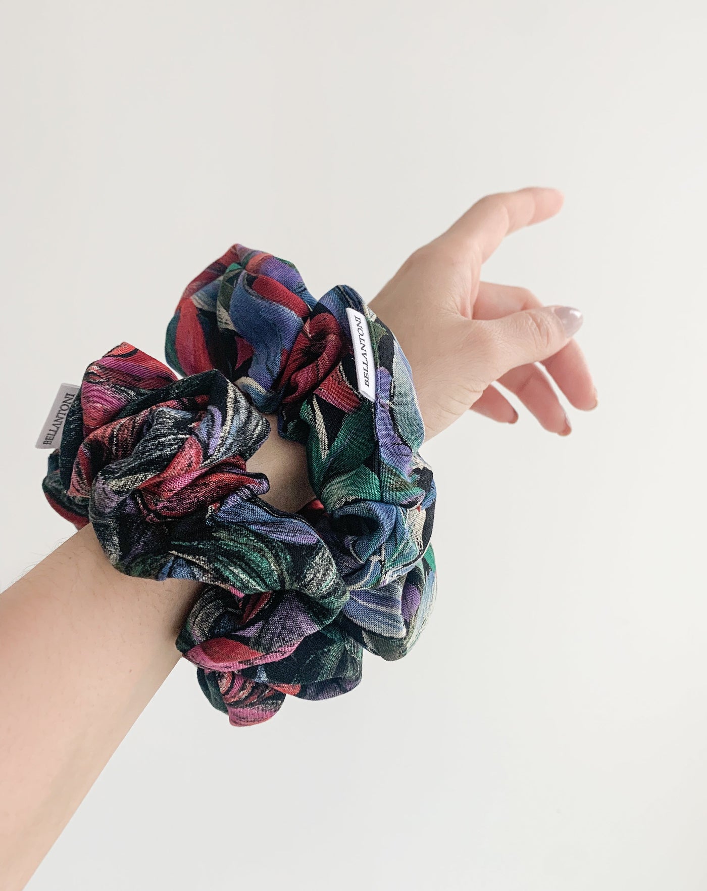Two reclaimed tropical floral classic scrunchie  on arm.